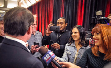 From SLCC to pro booths, women step into sports broadcasting Reporters surrounding a man for interviews