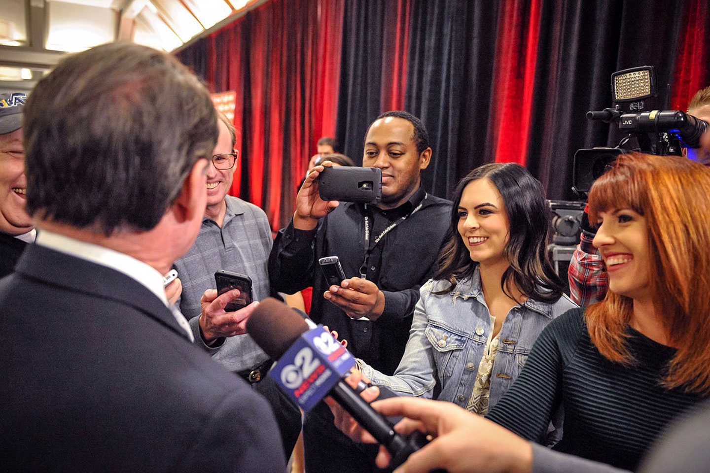 Reporters surrounding a man for interviews