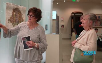 Globe News – March 18, 2026 Rosanna Lynne Welter, left, discussing quilted art with an exhibit attendee