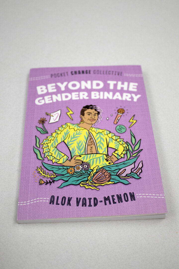 "Beyond the Gender Binary" book sitting on a table