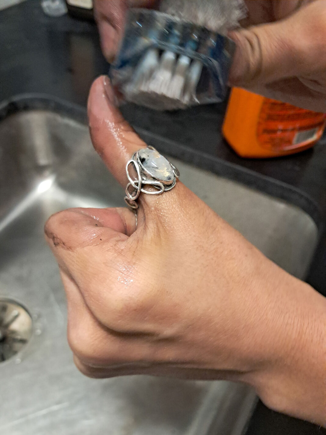 Ring being worn on thumb of a woman's hand