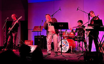 SLCC students showcase growth at mid-spring band concert Four students performing on stage under red and blue lights