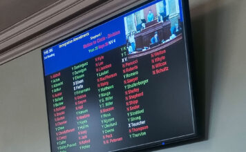 Utah House advances bill linking citizenship status to in‑state tuition access LED screen displaying legislative vote results