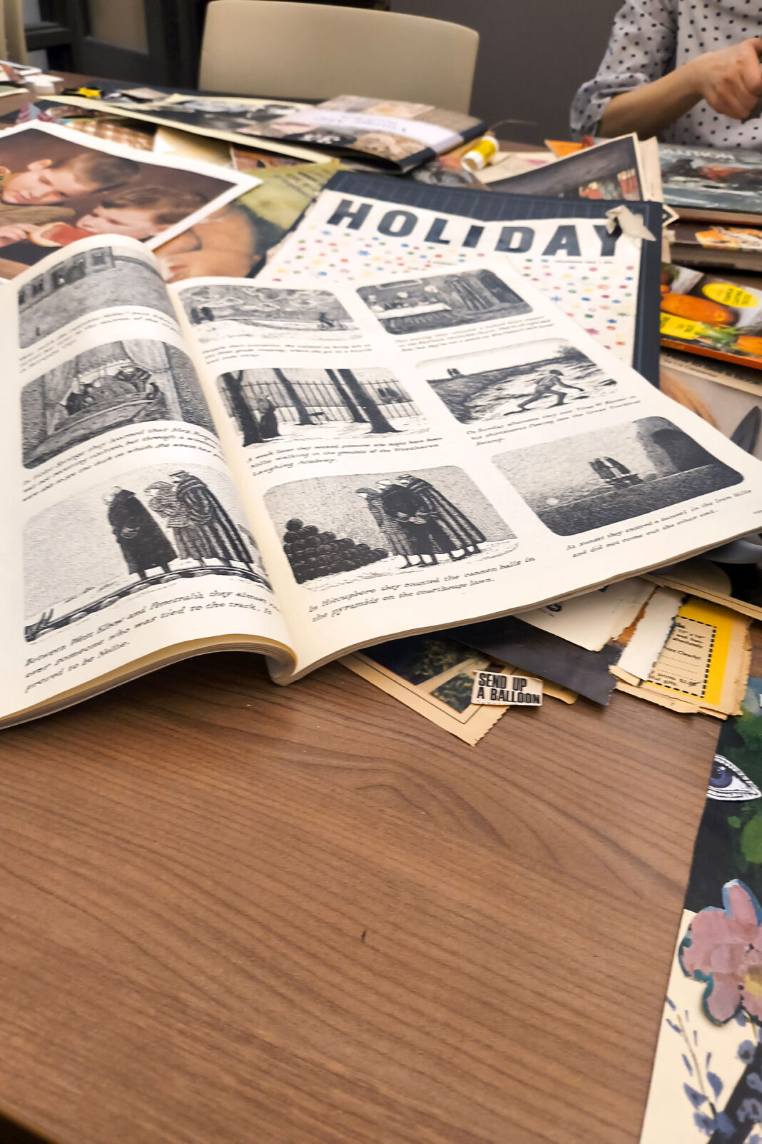Books, magazines and photographs scattered on a table