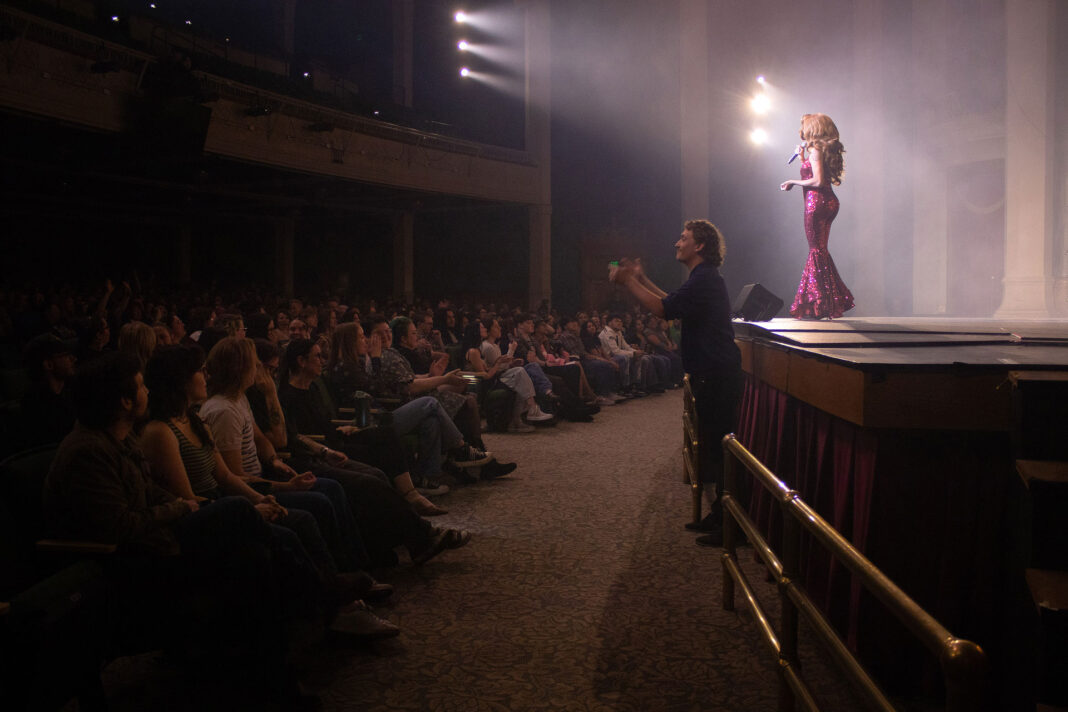 Angeria Paris VanMichaels standing on stage in front of large audience