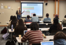 Workshop series teaches financial literacy Amanda explaining types of credit use during a presentation to students