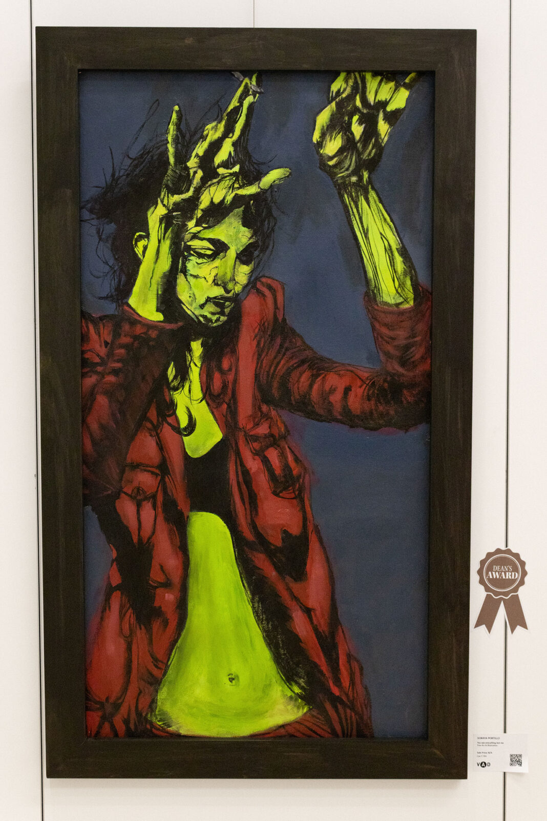 A framed painting of a human wearing a red jacket holding their hands above their head