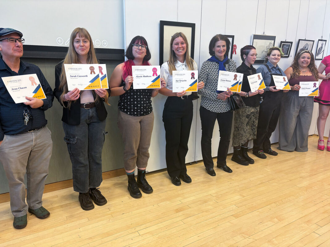 Artists standing in line holding their awards