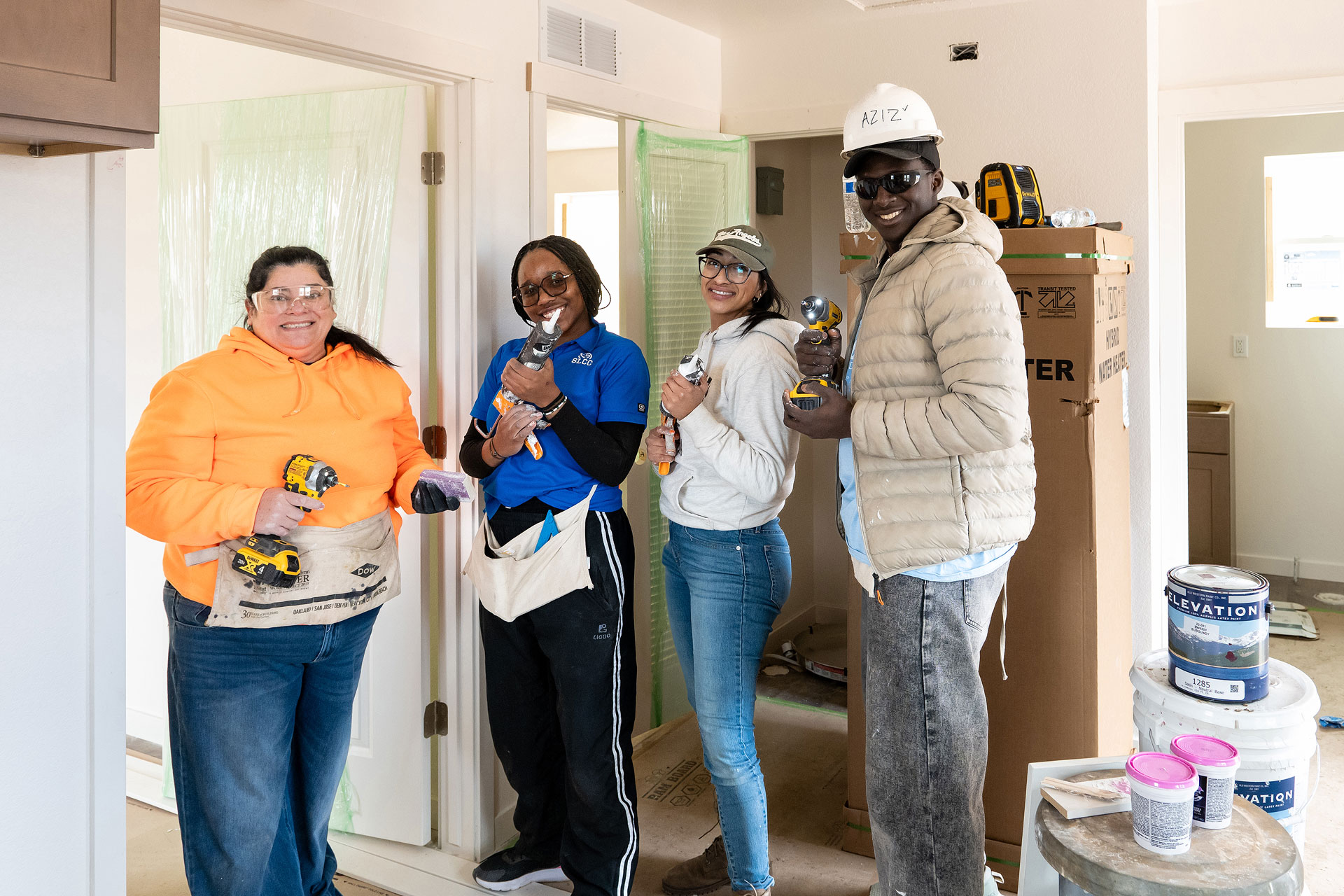 Four people working on house construction