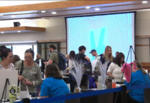 Health and wellness resources available to students struggling through the semester People gathering information at tables inside the Student Center