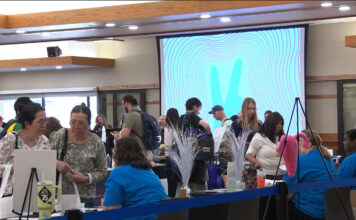 Health and wellness resources available to students struggling through the semester People gathering information at tables inside the Student Center