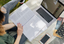 Letter to the editor: How occupational therapy principles can benefit college students: You cannot pour from an empty glass Woman reading an open book outside under shade with laptop and phone