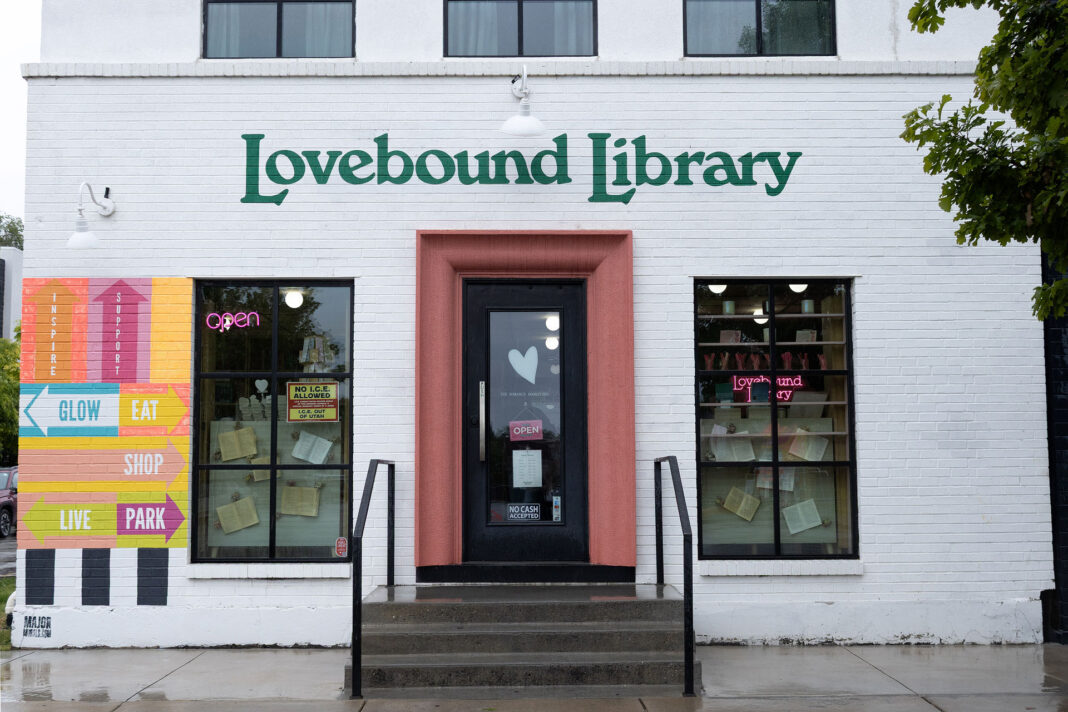 White painted brick building with Lovebound Library in green