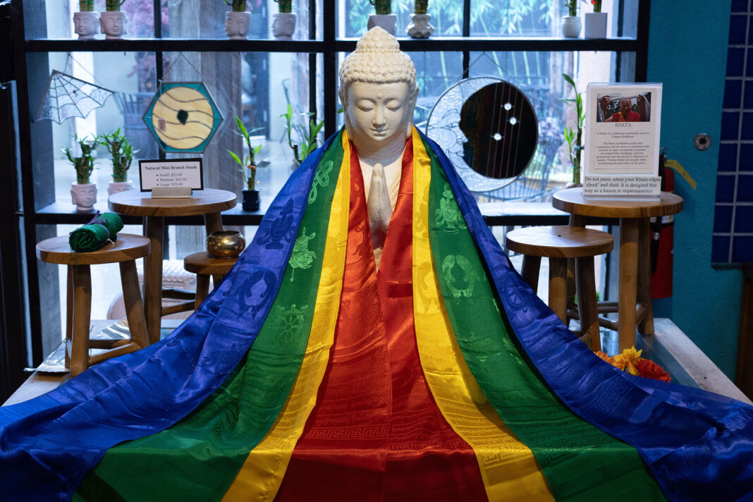 Buddha statue adorned with multicolored robe