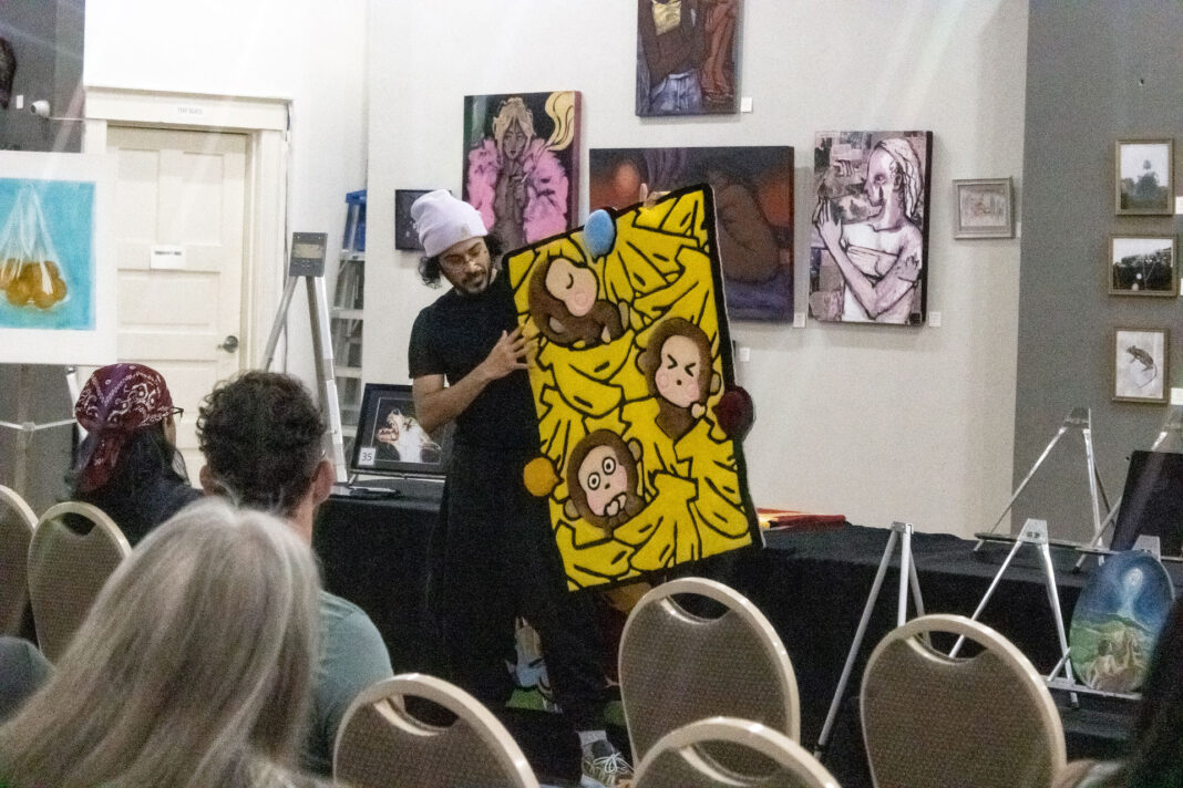 Landscape shot of an art gallery participant presenting their art piece