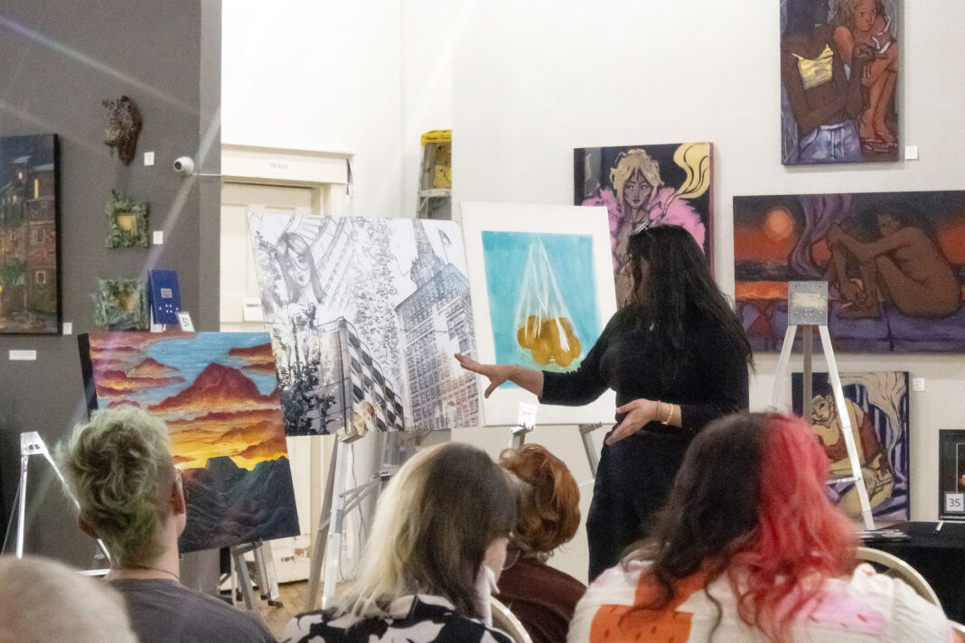 Artist presenting their artwork