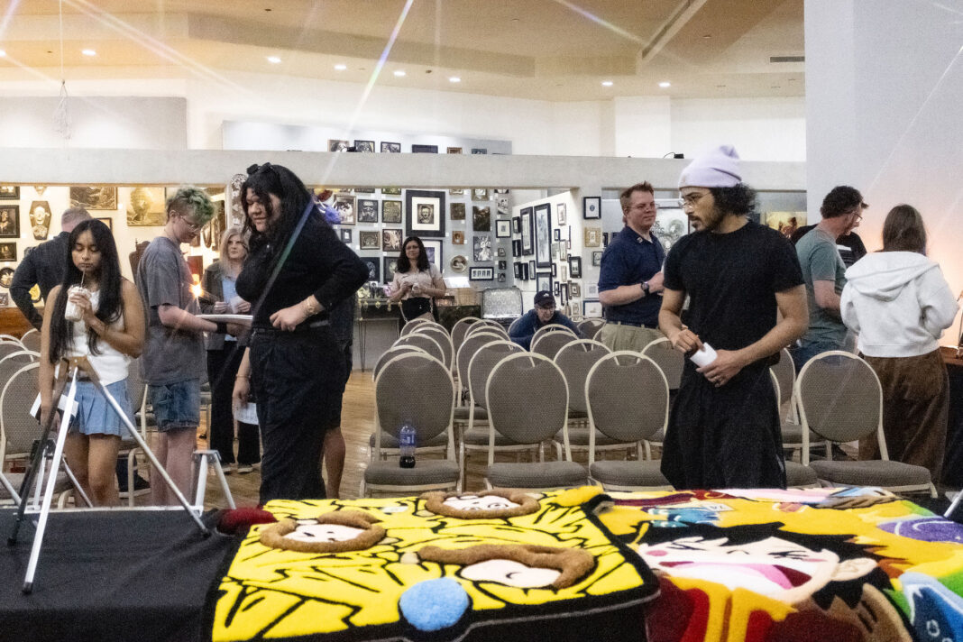 A group of people viewing displayed art
