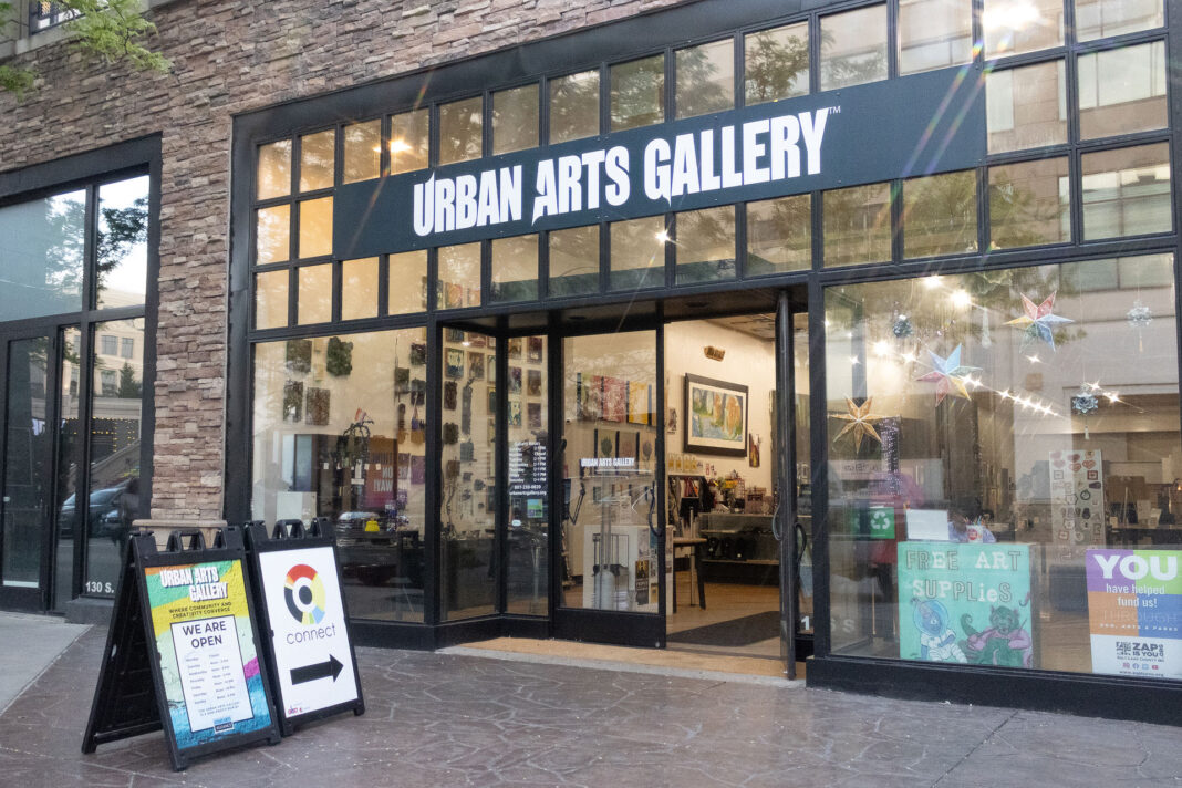 Landscape shot of the front doors of the Urban Arts Gallery with a small UAA Connect sign