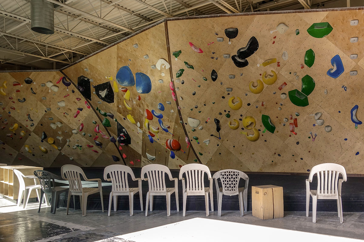 Chairs placed in front of a large climbing wall