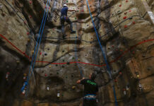 How SLCC is helping to uplift Utah’s climbing legacy Climber ascending a rock wall with an instructor standing below