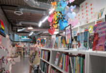 Queer book recommendations for Pride Month and beyond Rainbow-colored decorations hanging inside a bookstore