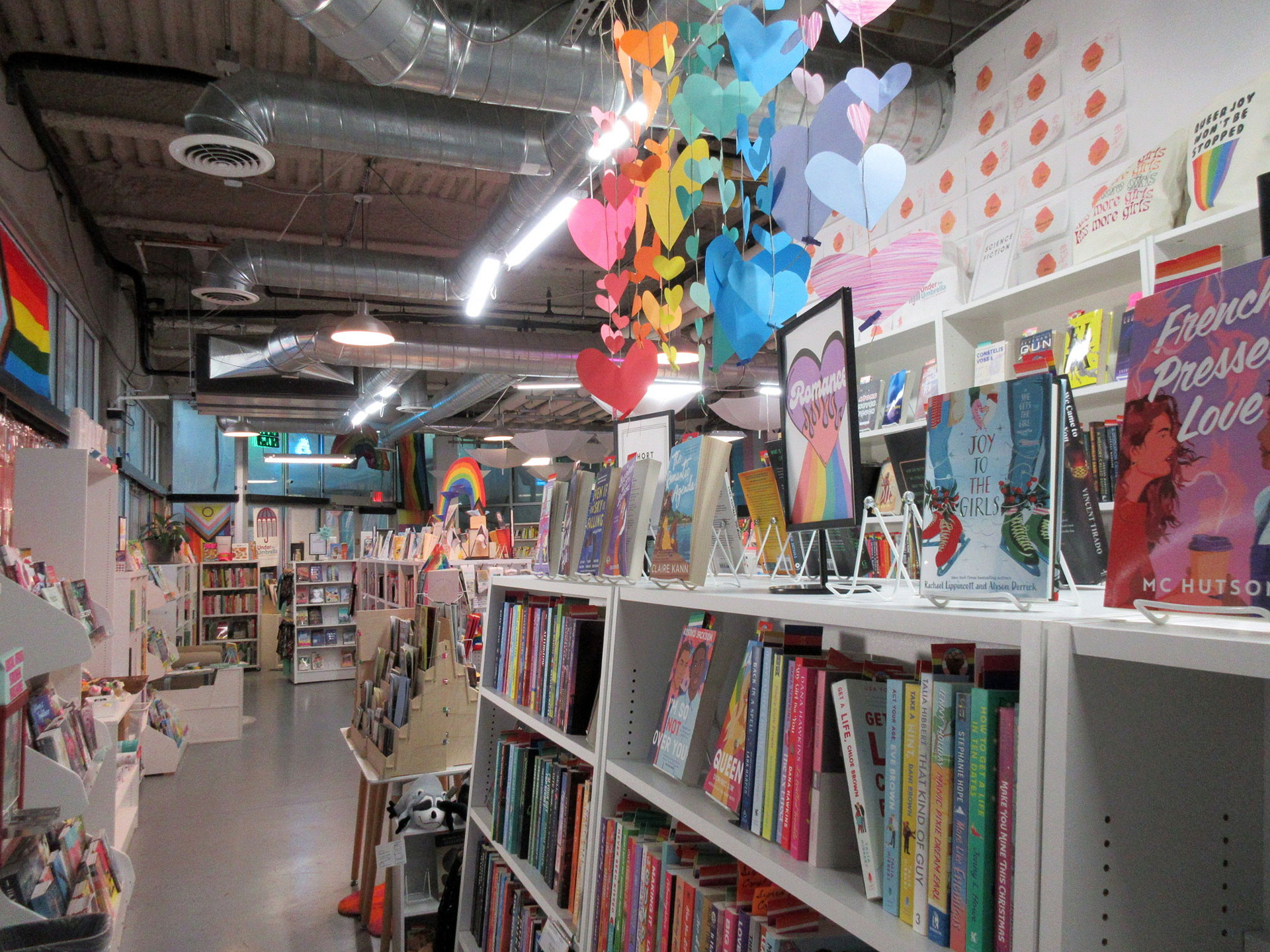 Rainbow-colored decorations hanging inside a bookstore