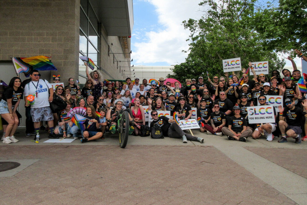 Large group of people gathering for a photo outside