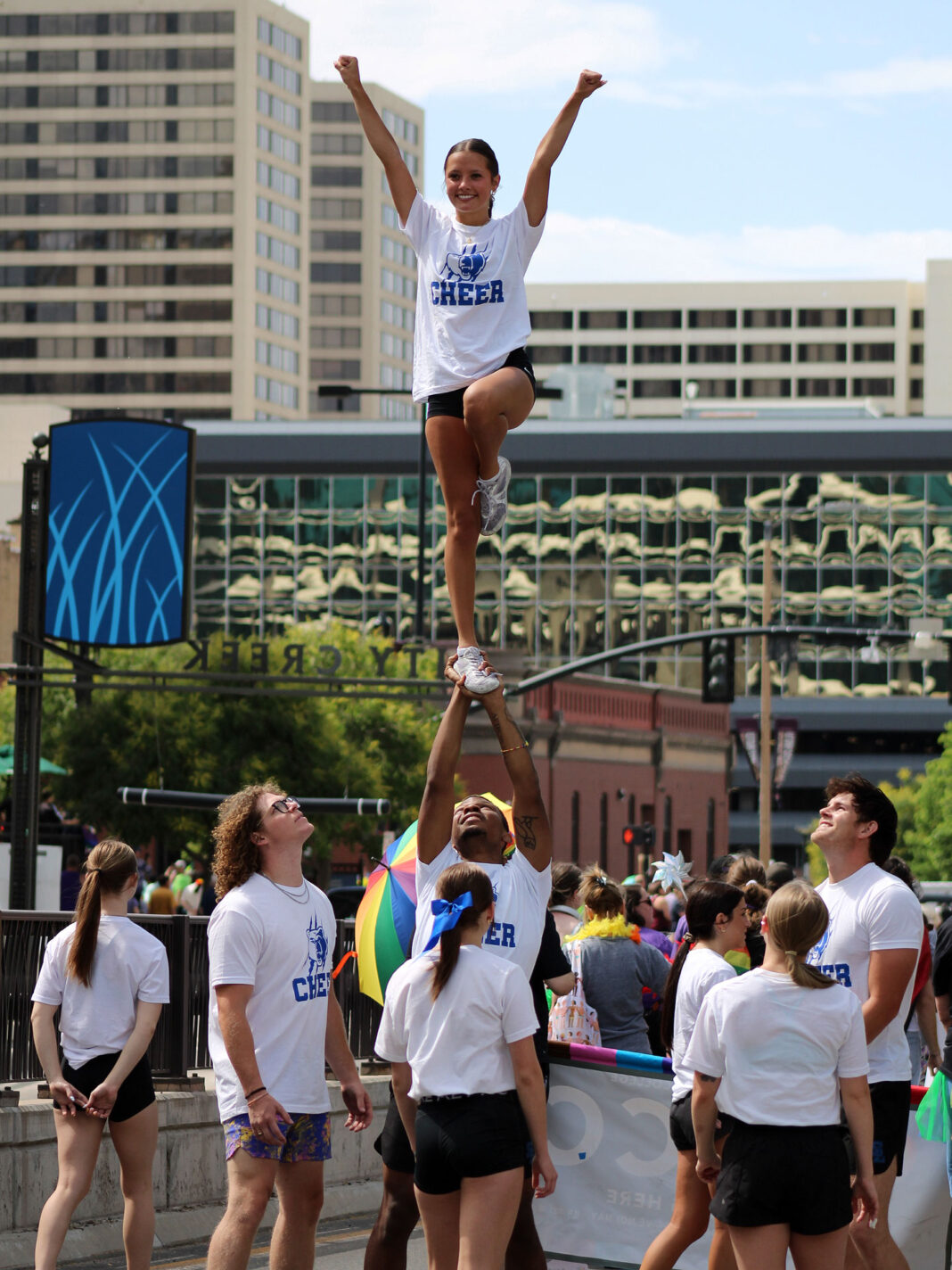 Cheerleaders performing on a downtown street during a parade
