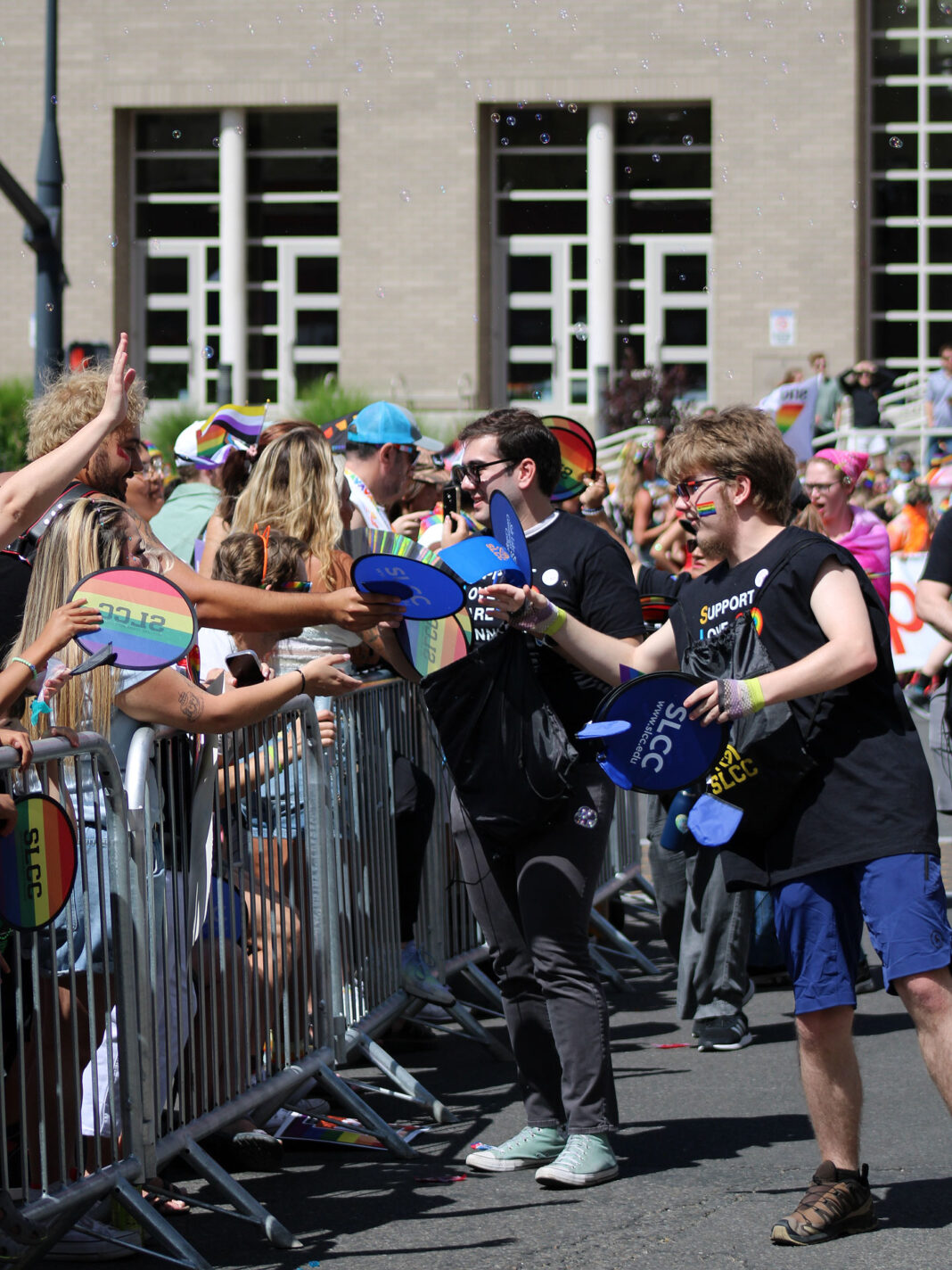 Parade walkers interacting with attendees on a city street