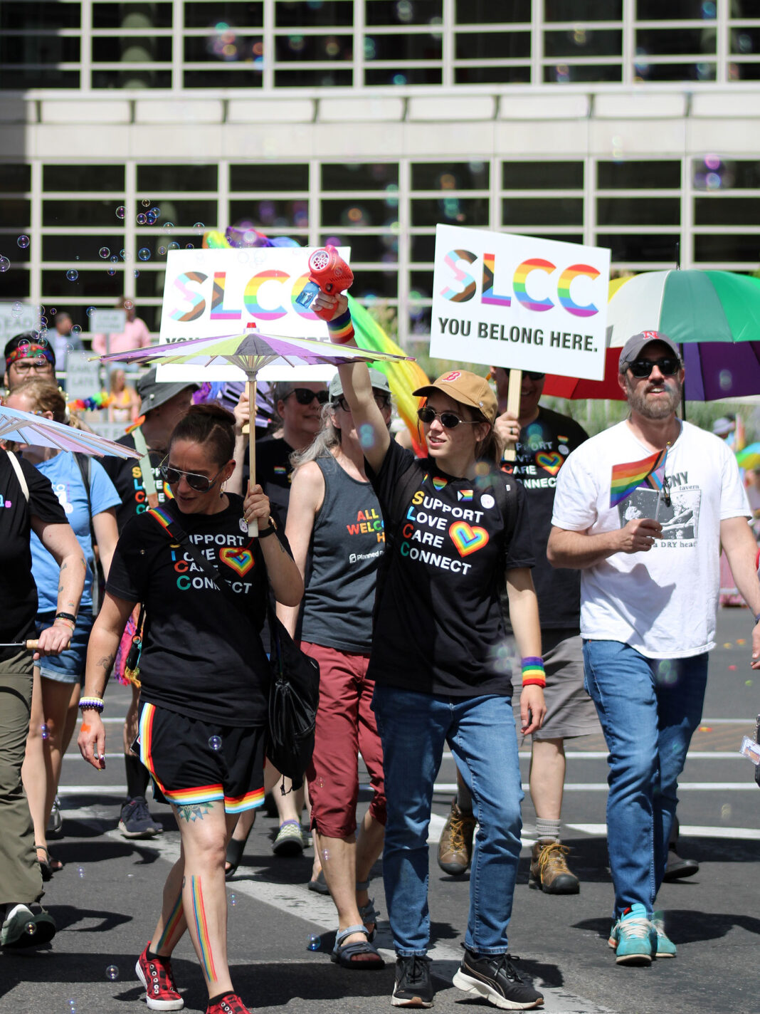 Pride parade participants walking on a city street