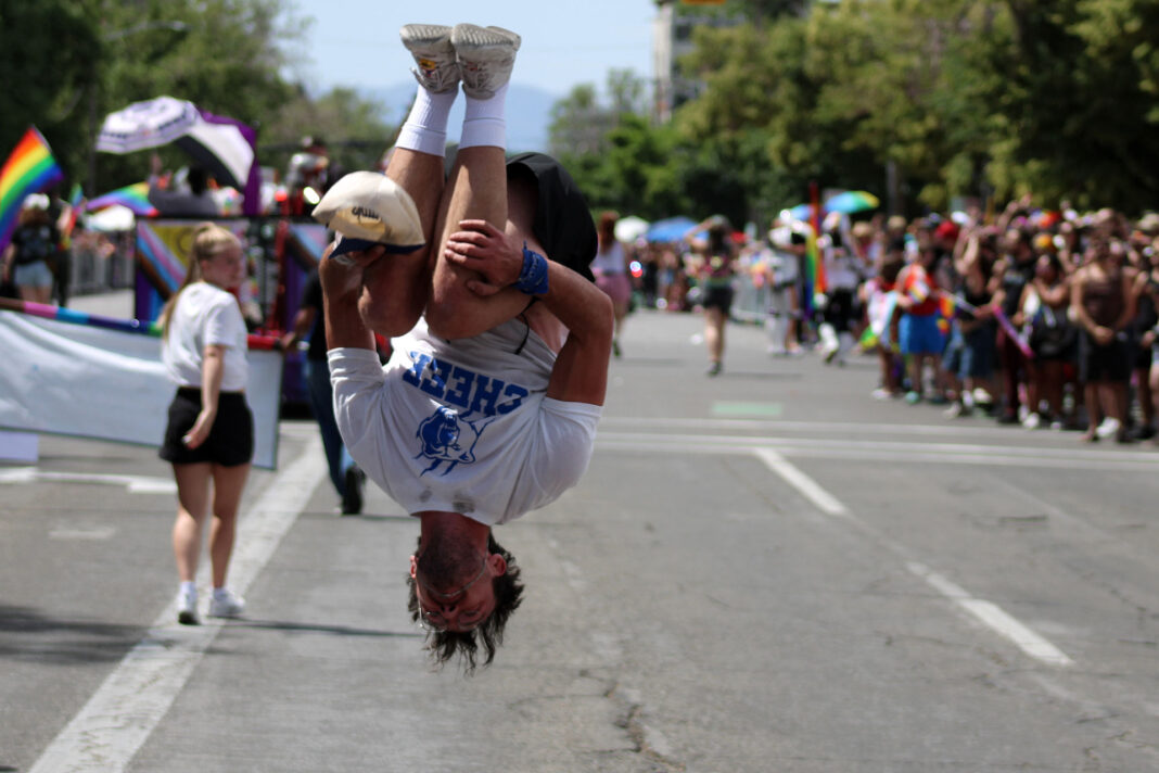 A cheerleader performing on a city street during a parade