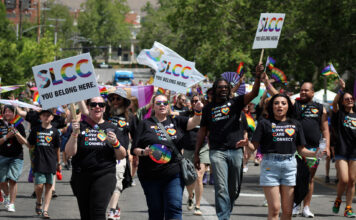 In photos: SLCC shows its true colors in the 2026 Utah Pride Parade Pride parade participants walking down a city street