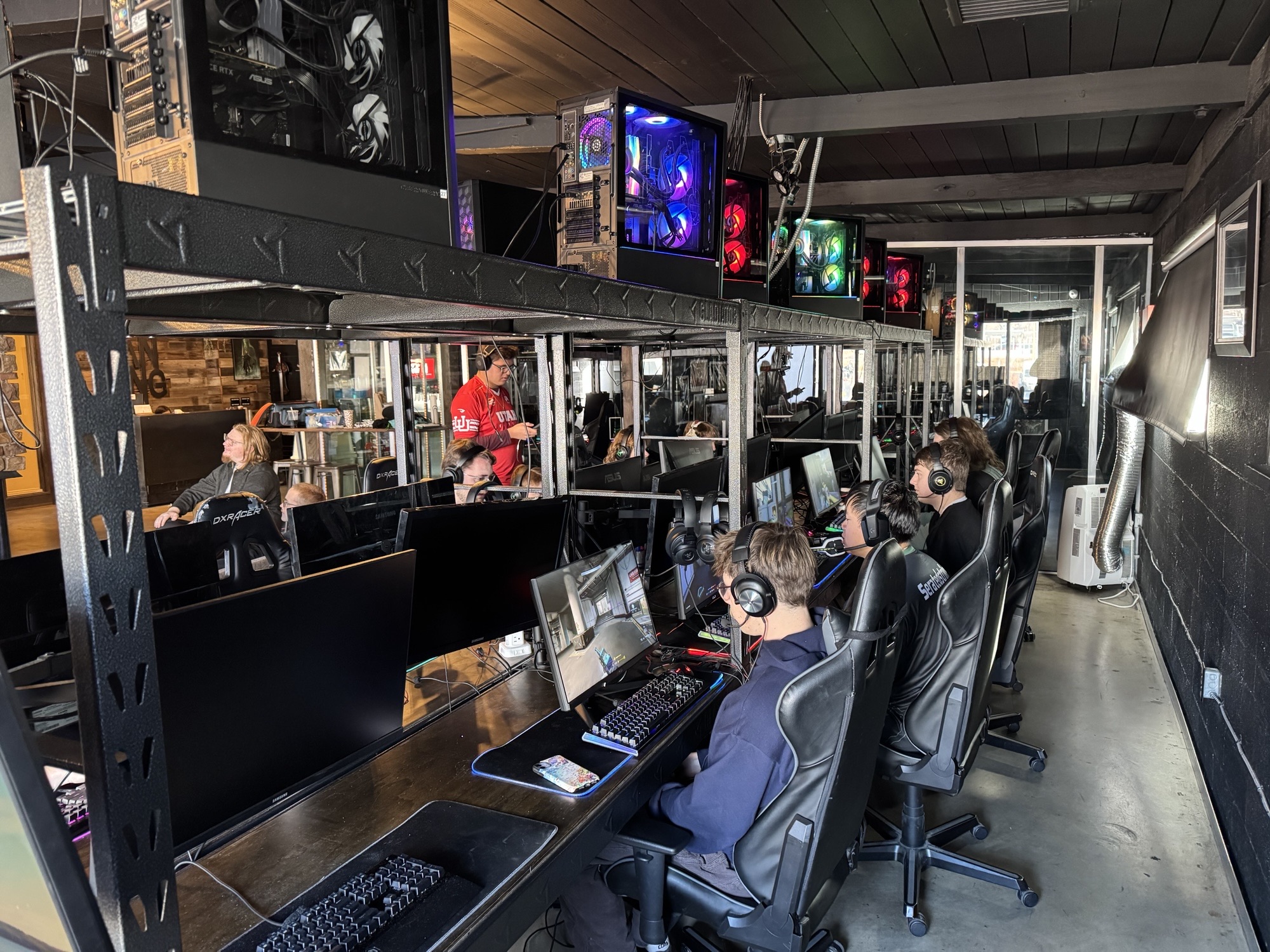 Room filled with people playing computer games