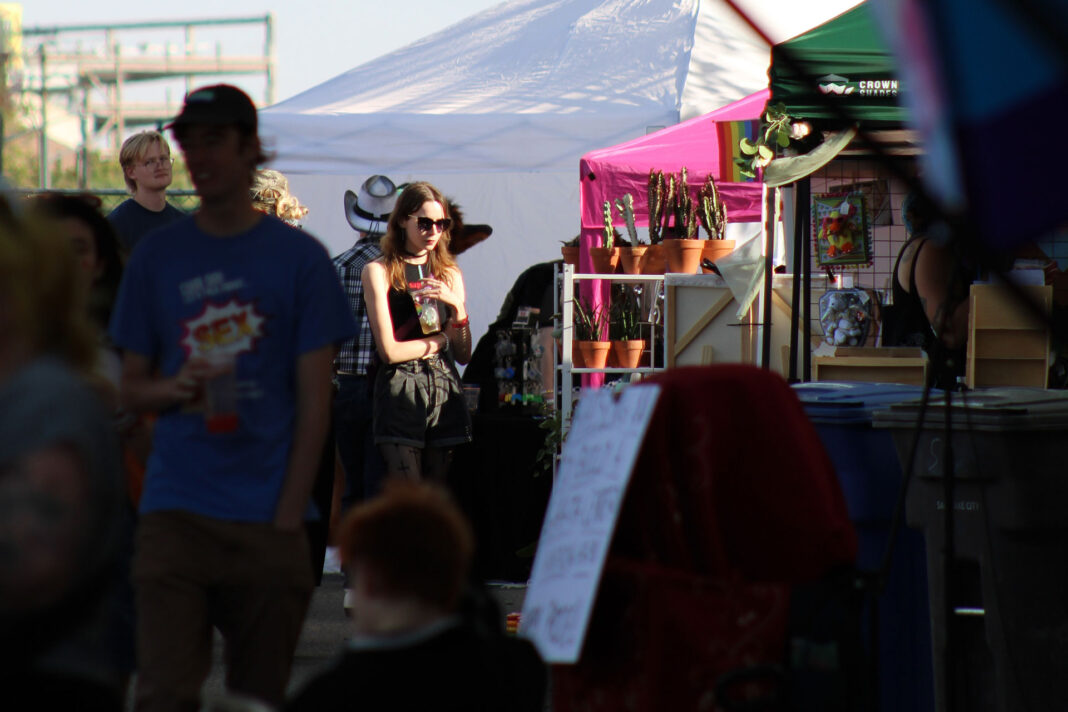 Festivalgoers browsing different vendor booths