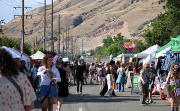 In photos: Continuing SLC Pride’s ‘by community, for community’ Festivalgoers walk past vendor booths on a city street