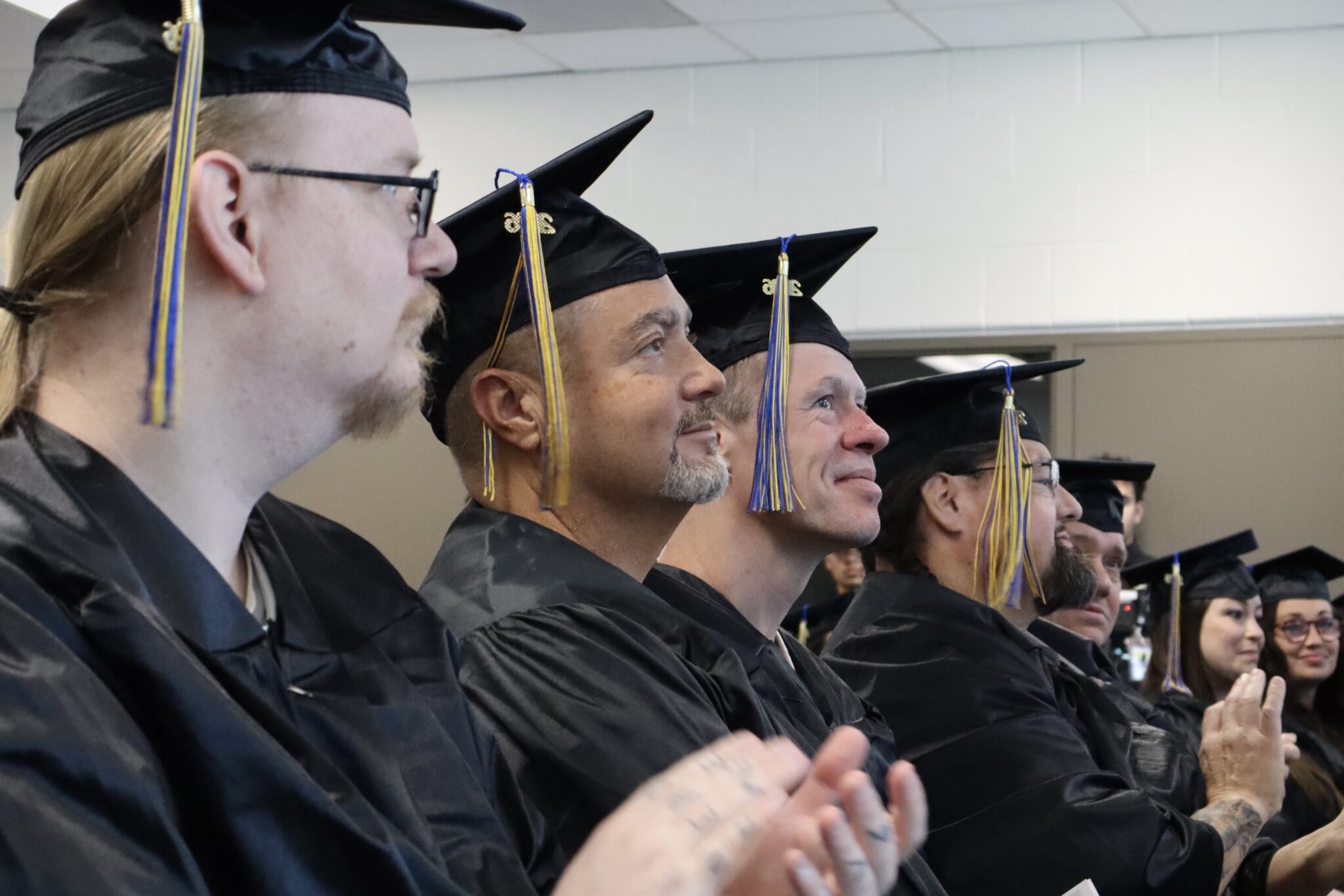 SLCC graduates wearing black caps and gowns