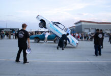 In Photos: Hop into College brings lowrider community to SLCC’s Westpointe Center People standing around a car doing hydraulic tricks