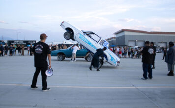 In Photos: Hop into College brings lowrider community to SLCC’s Westpointe Center People standing around a car doing hydraulic tricks