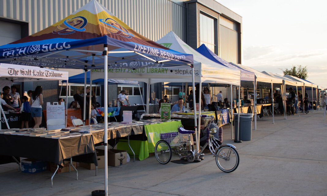 Branded canopies set up in a row outside a campus building