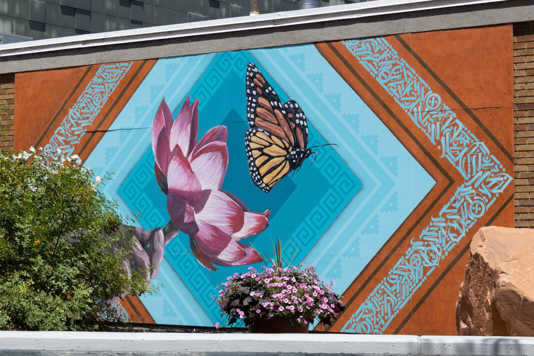 Brick wall adorning a large mural of a Monarch butterfly