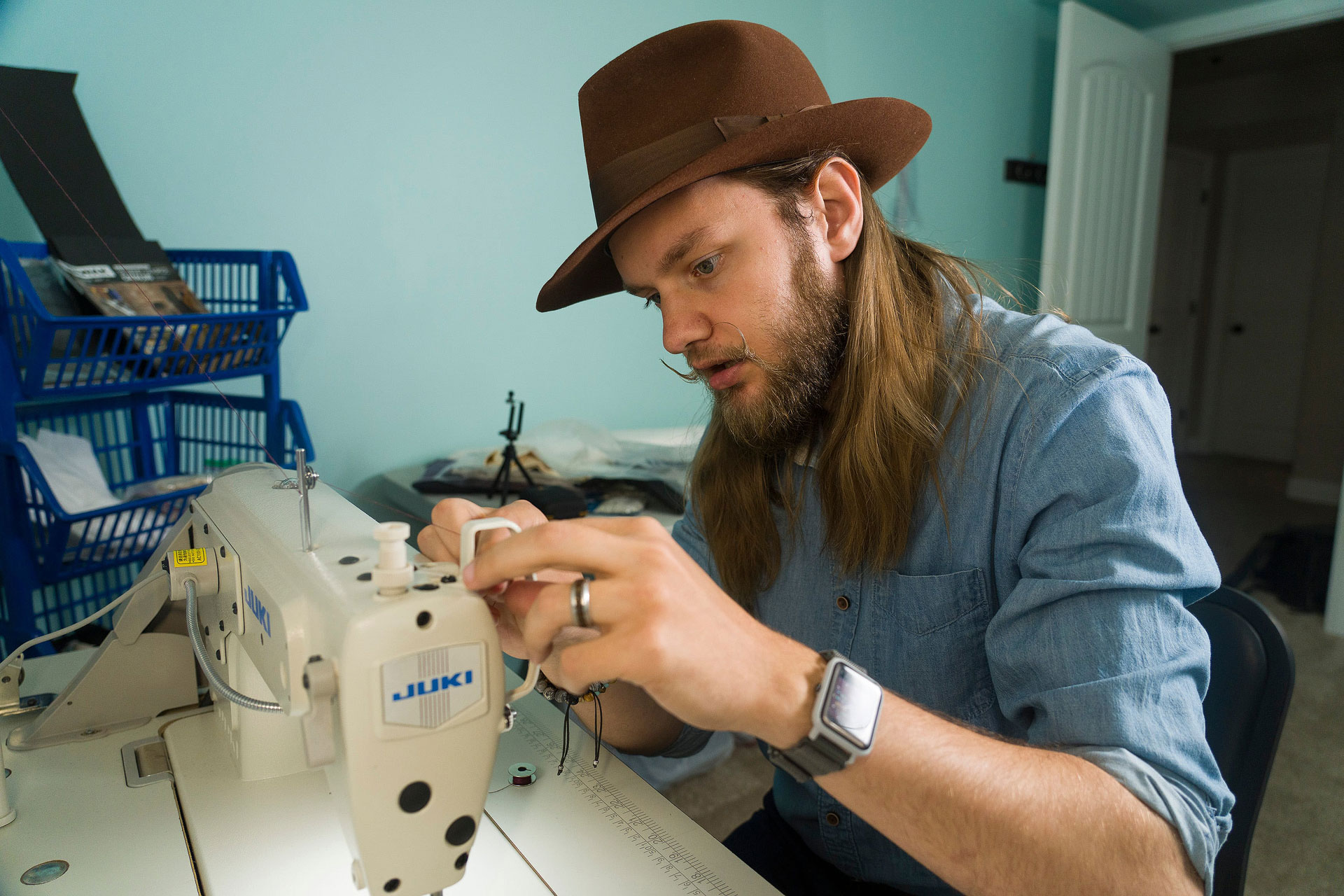 Joseph seated at a sewing table and crafting his Great Salt Lake fashion