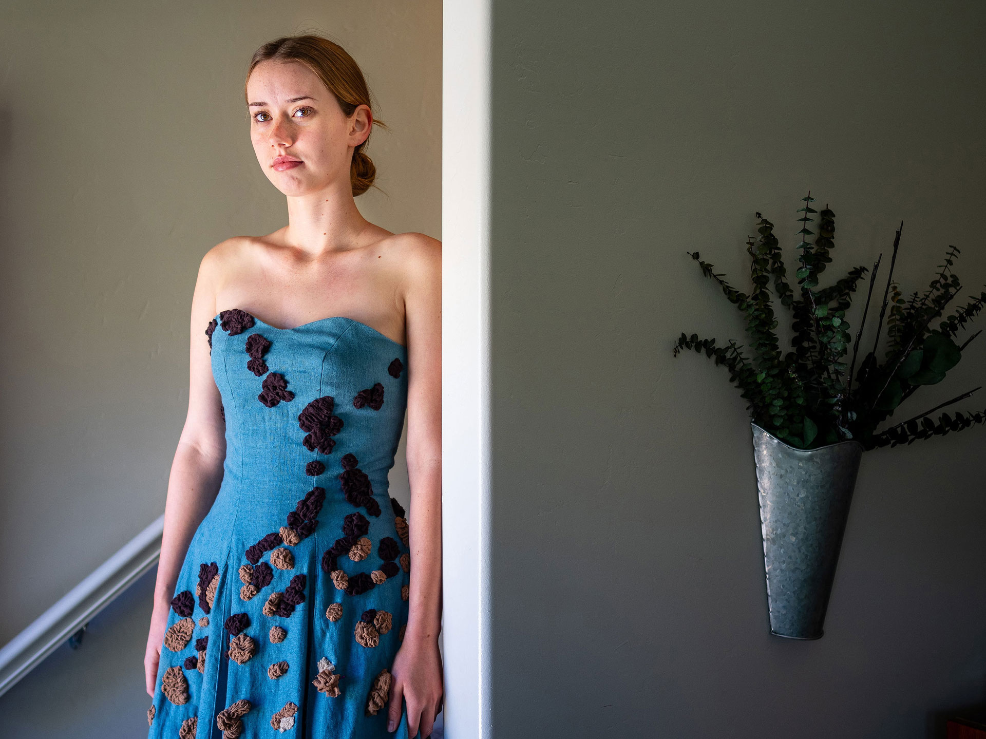 Cecily standing in a doorway modeling her sister's dress design