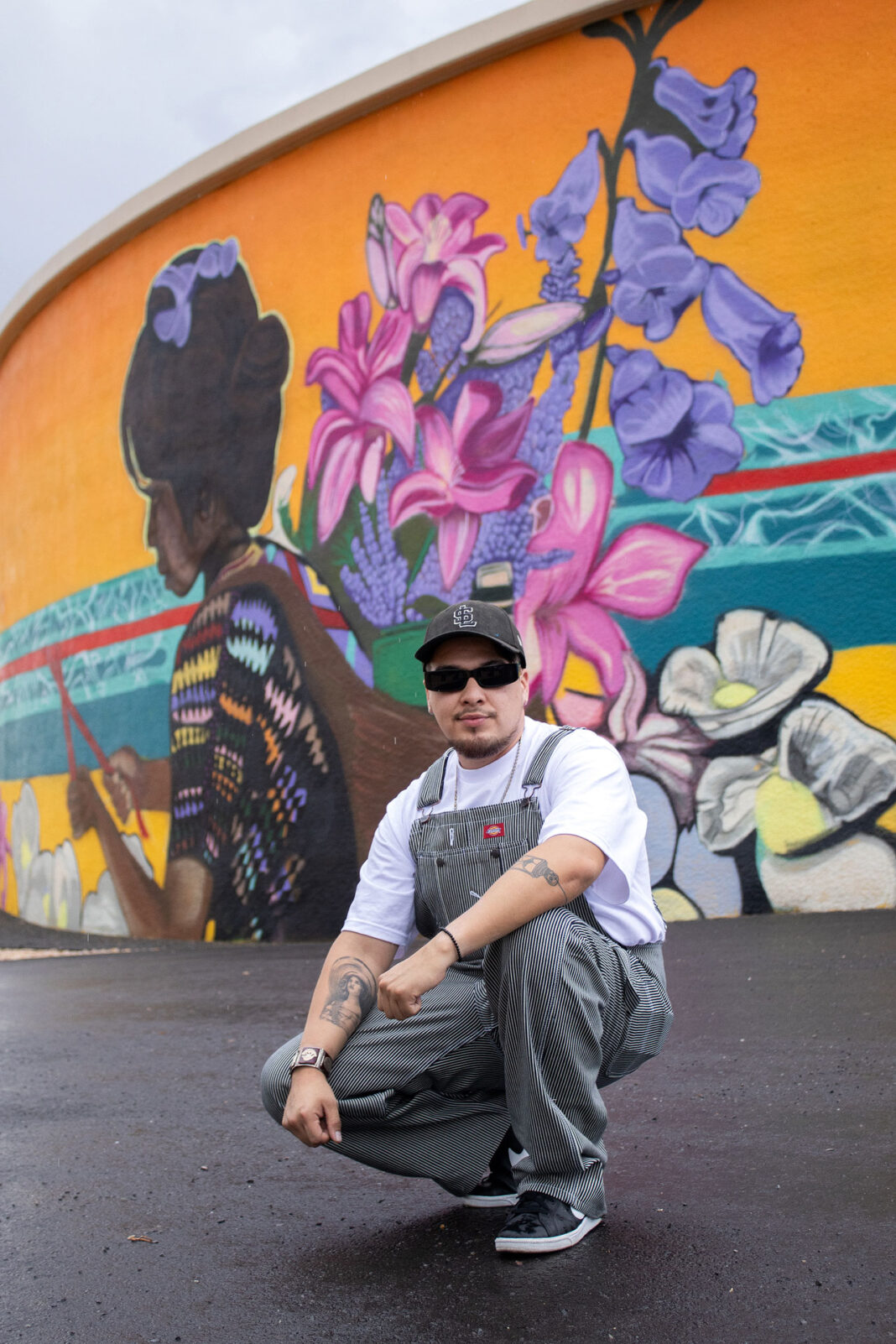 Beto Conejo attending the unveiling of his mural, in background