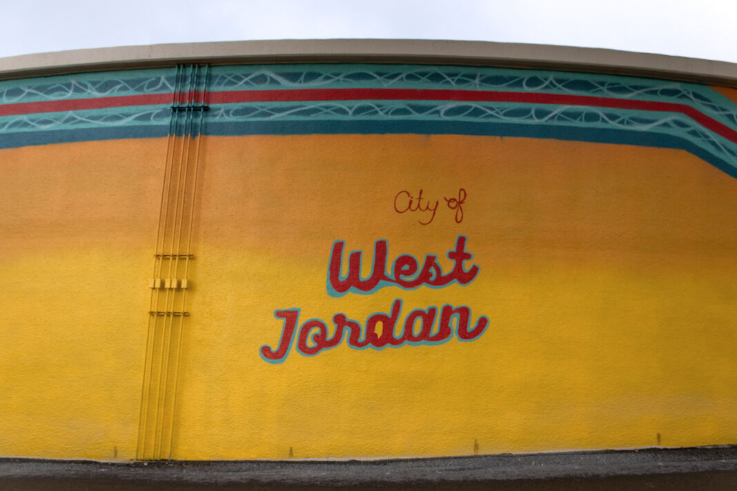 "City of West Jordan" painted on a wall of a water tank as part of a mural