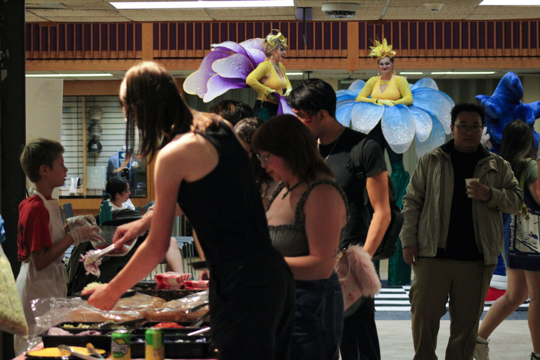 People standing in line being served food