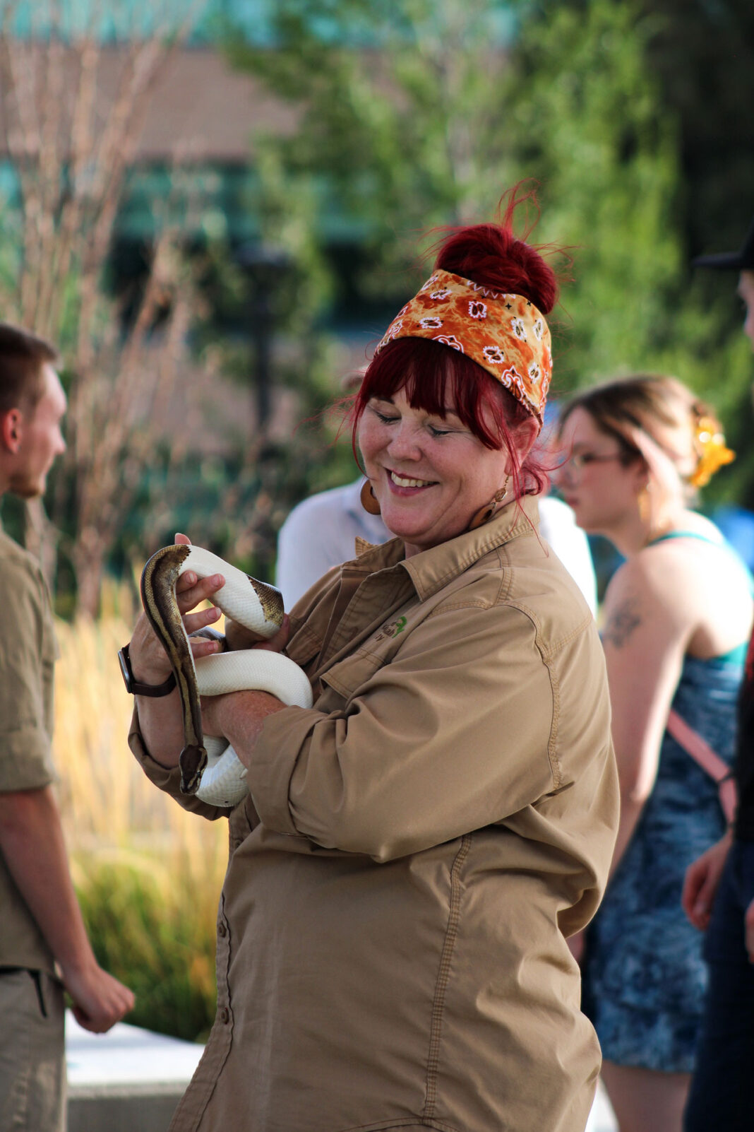 Snake handler smiling with python