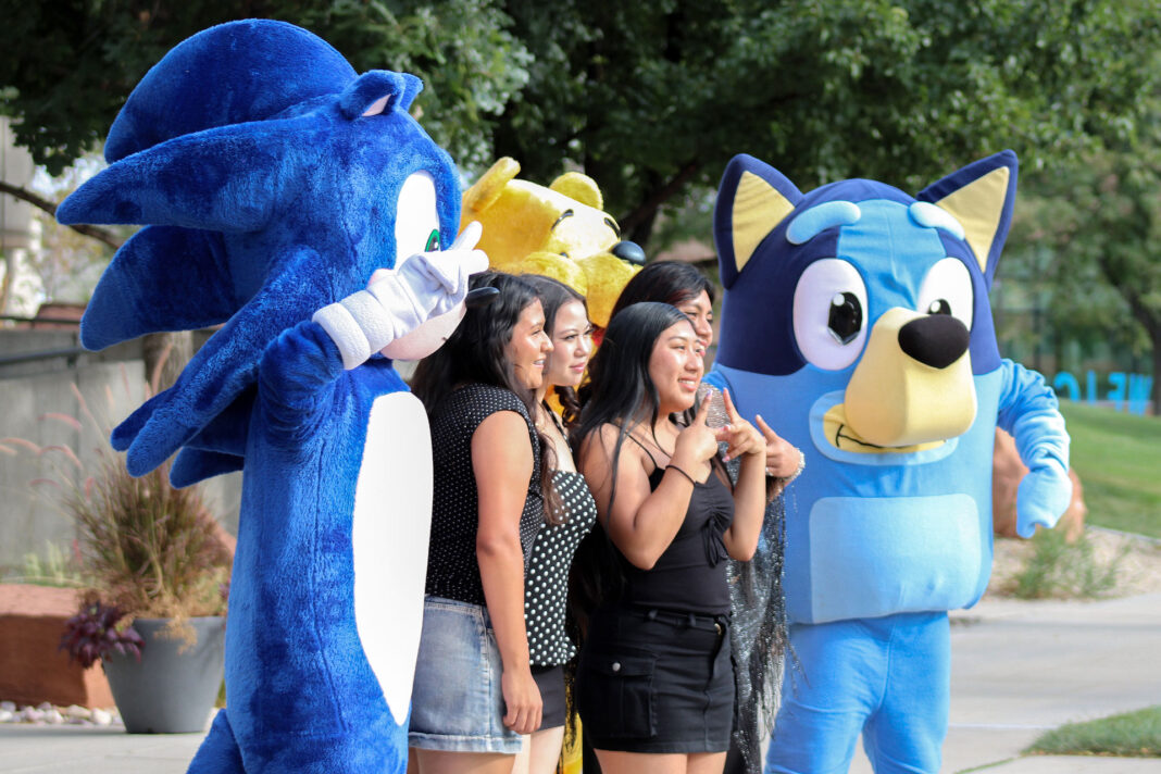 Festivalgoers posing for a photo with mascots