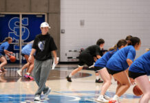 SLCC’s new head coach leads the women’s basketball team with a ‘hold the rope’ approach Coach Newton, wearing a hat, observing players at a practice