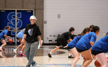SLCC’s new head coach leads the women’s basketball team with a ‘hold the rope’ approach Coach Newton, wearing a hat, observing players at a practice