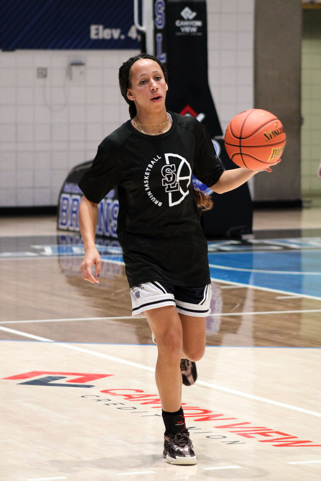 Summer running up the court with the basketball
